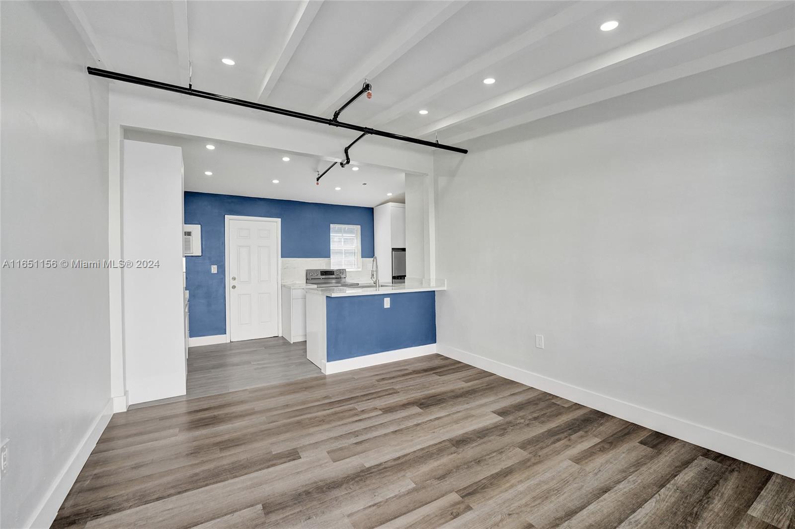 a view of kitchen with wooden floor