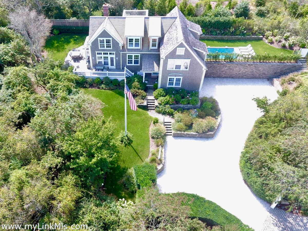 an aerial view of a house with a garden and plants