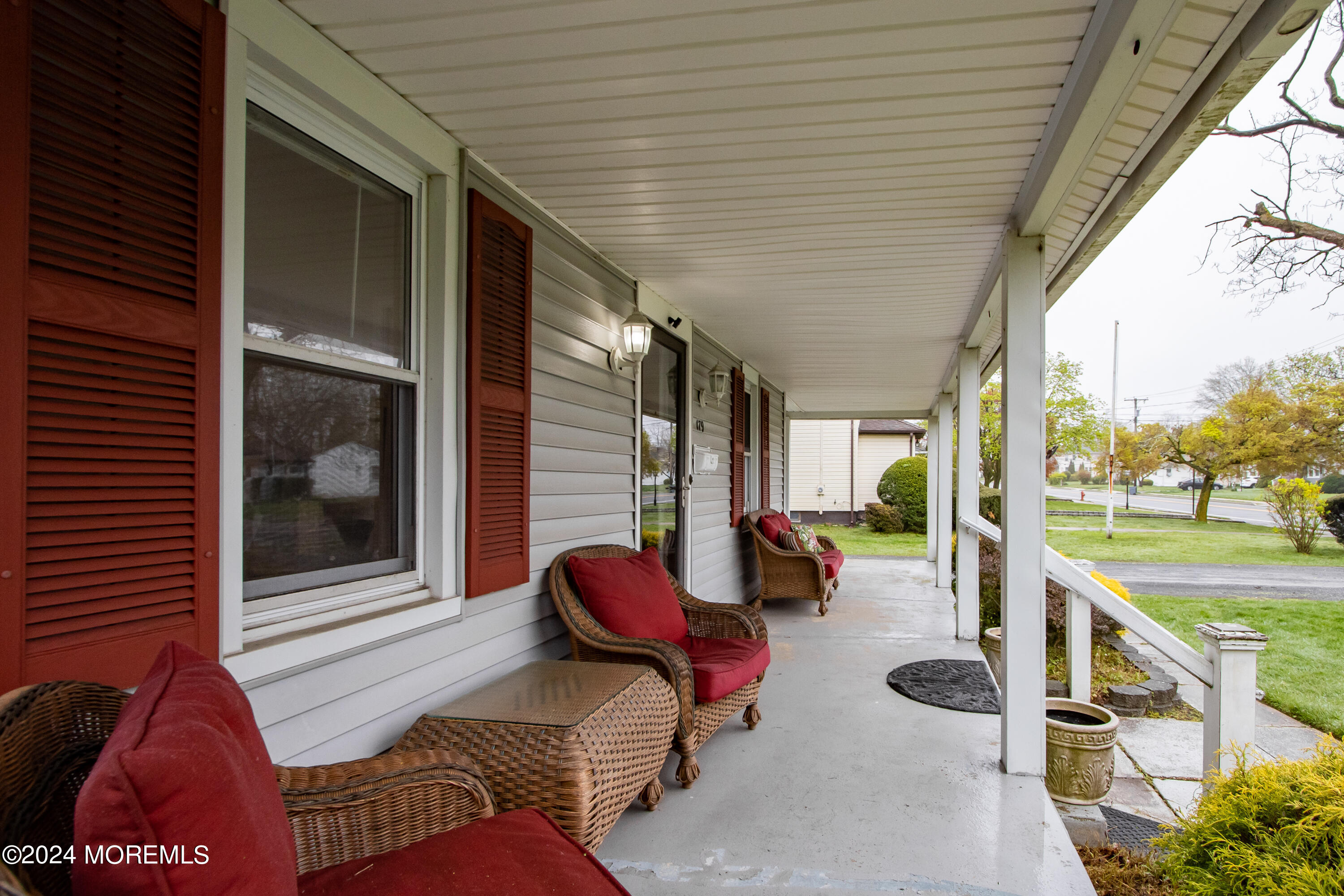 a balcony view with a couch and chairs