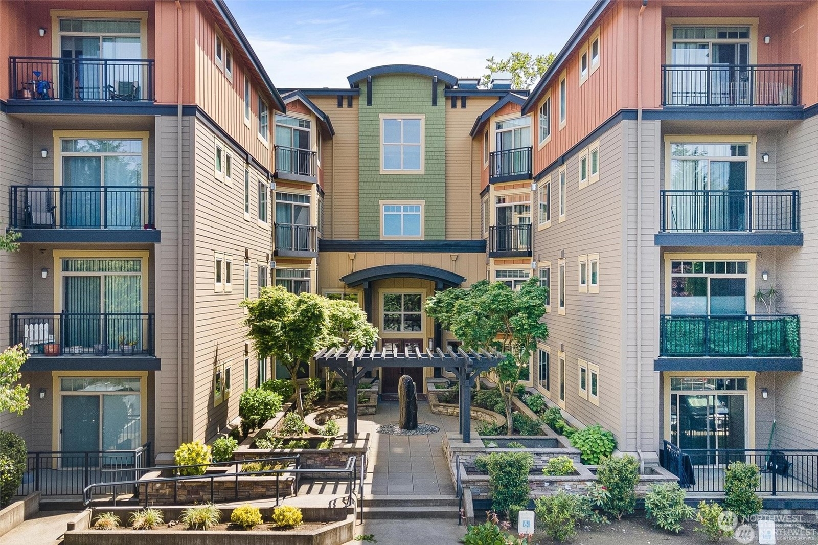 a front view of a building with a garden