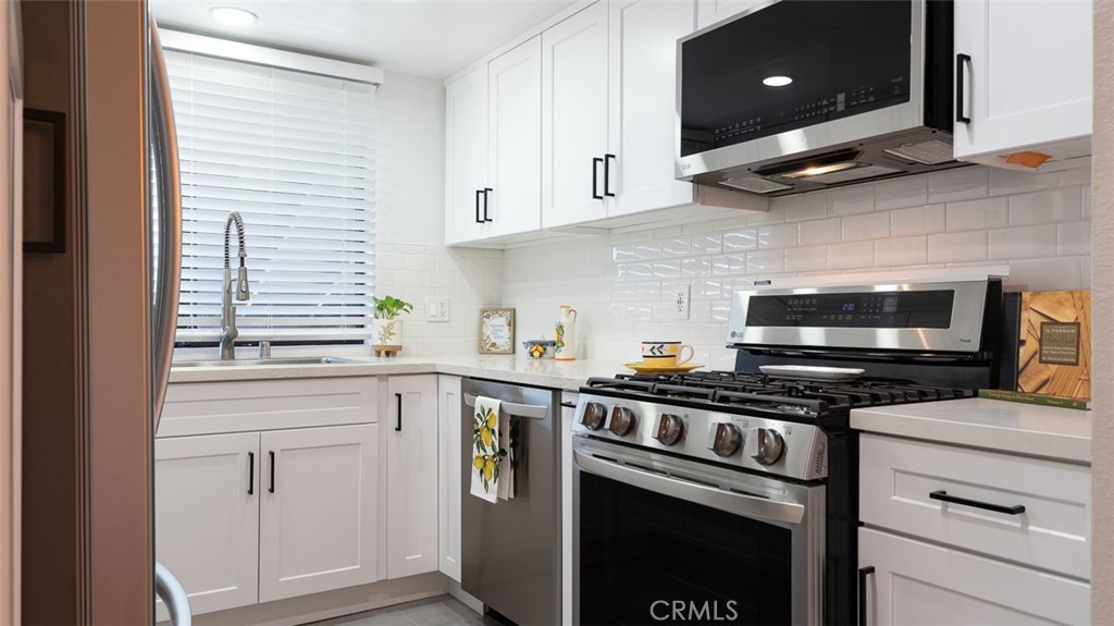 a kitchen with appliances cabinets and a window