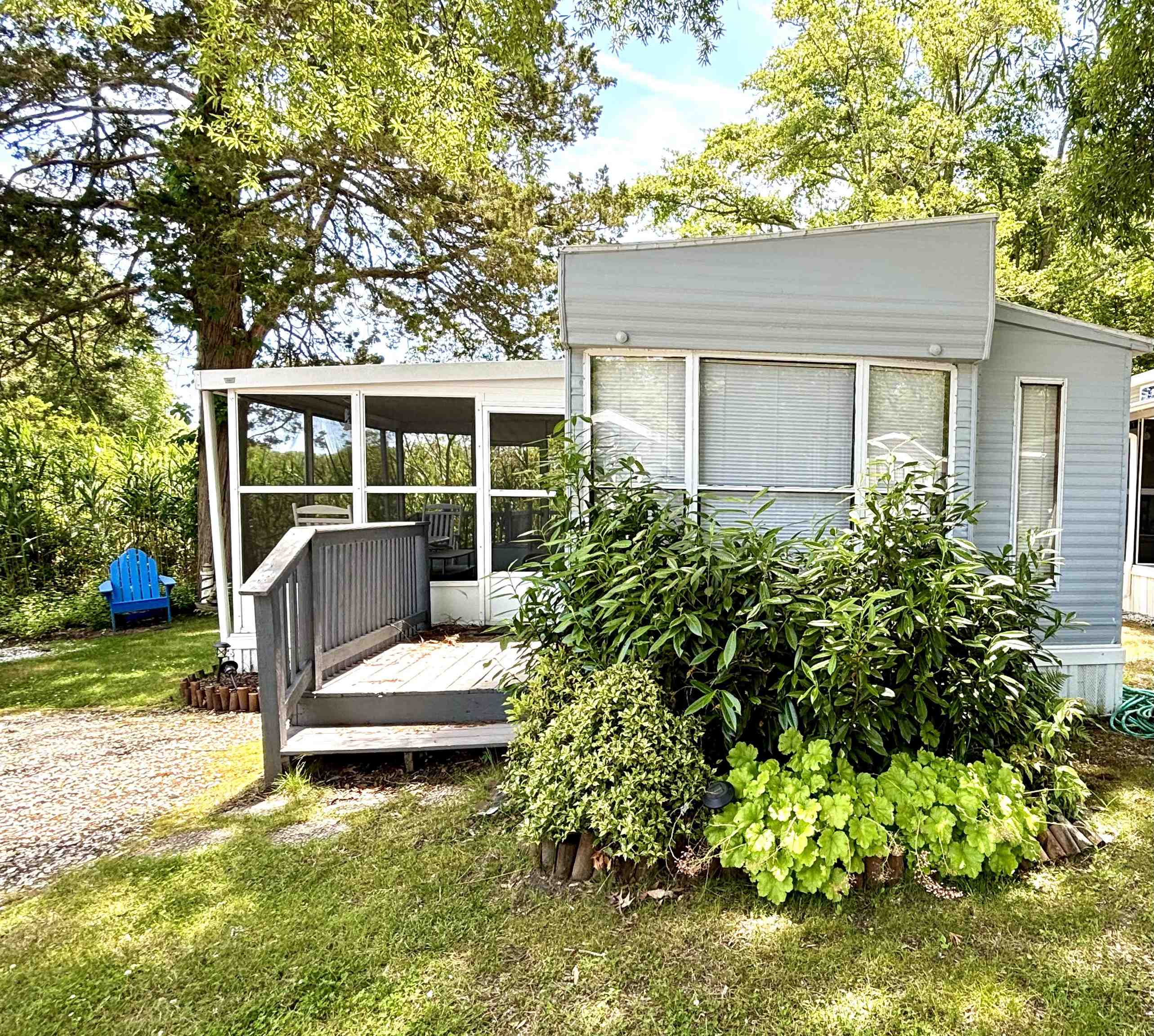 a view of a house with backyard sitting area and garden