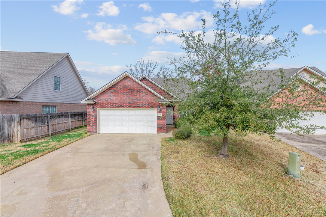 a view of a house with a yard and garage