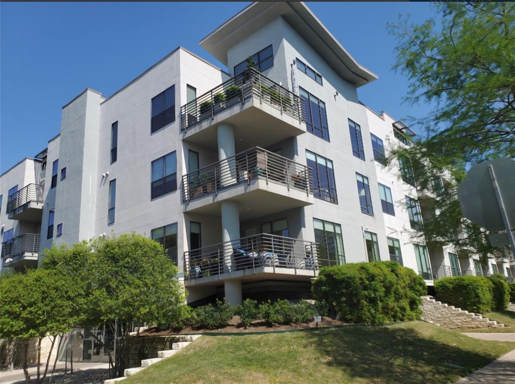 a front view of a building with a garden