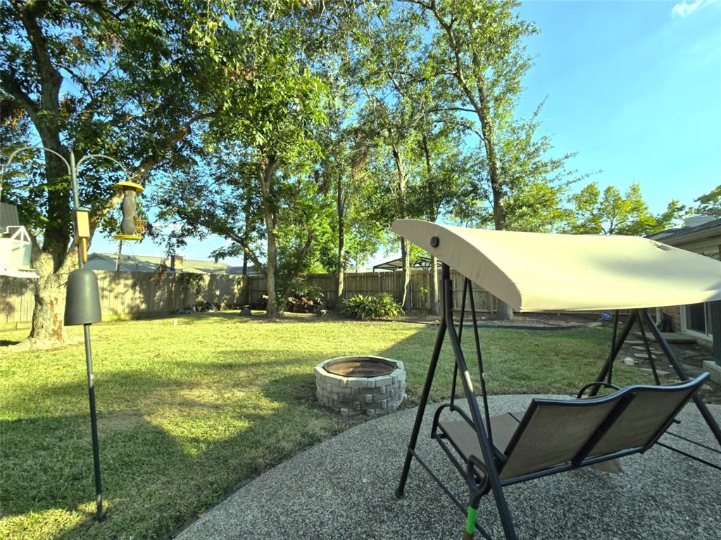 a view of backyard with swimming pool and seating