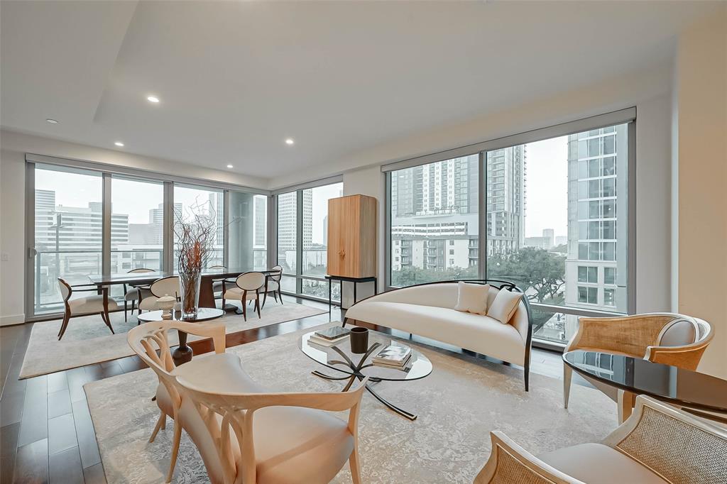 a living room with furniture and large windows