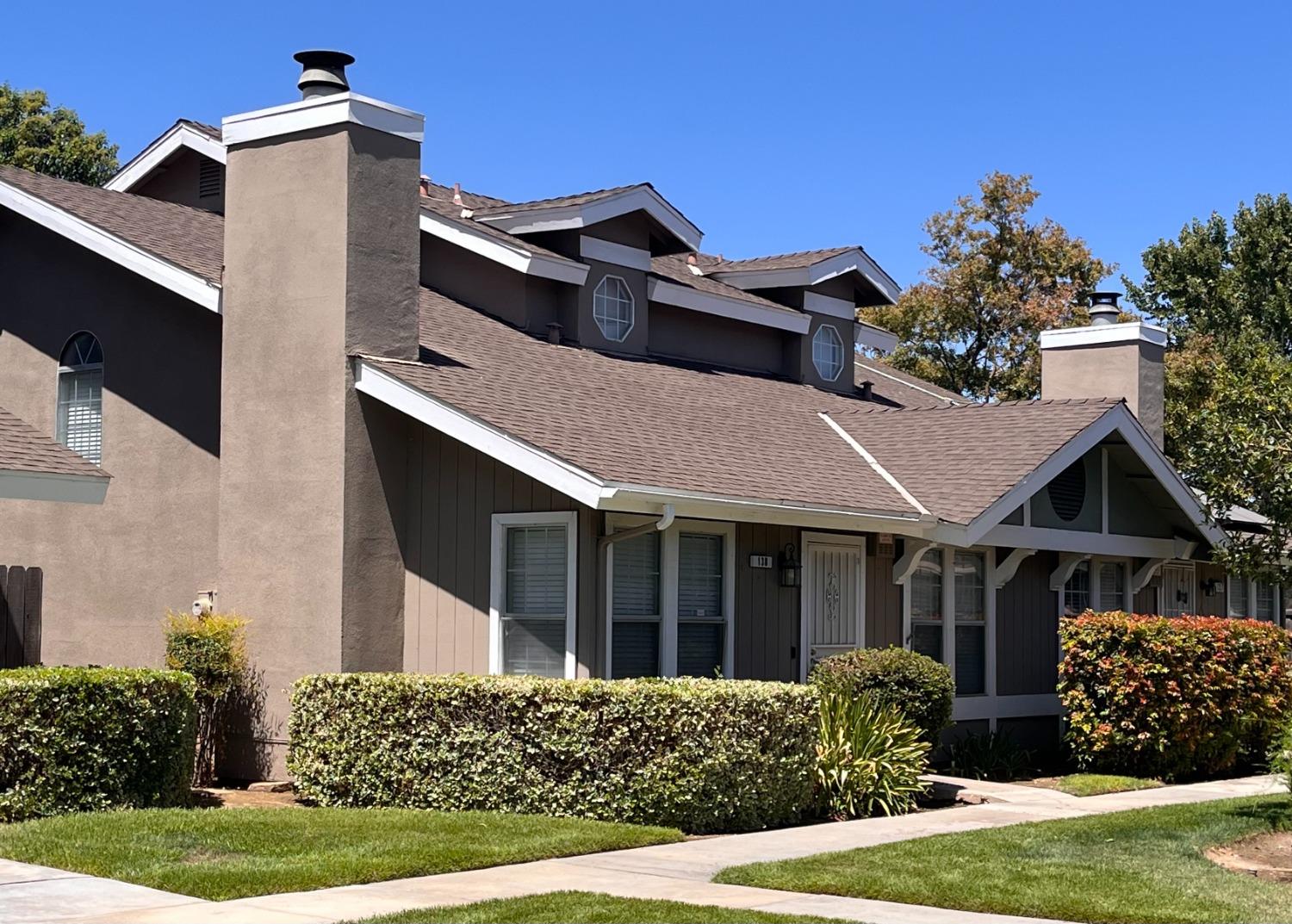 a front view of a house with garden