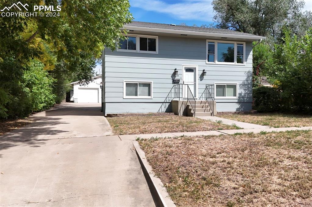 Bi-level home with an outbuilding and a garage