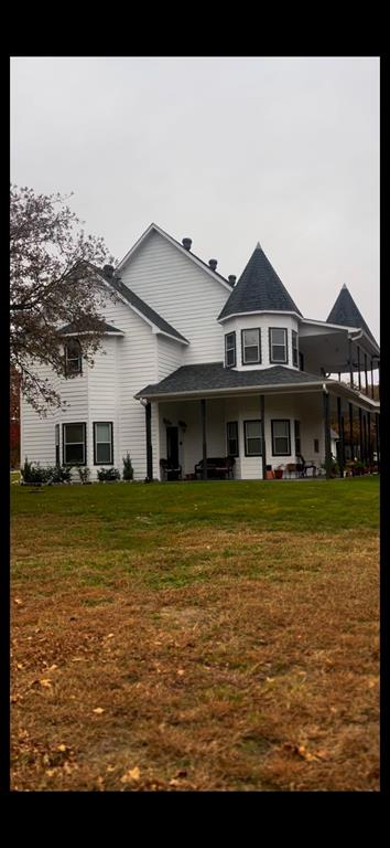 a front view of a house with a large swimming pool