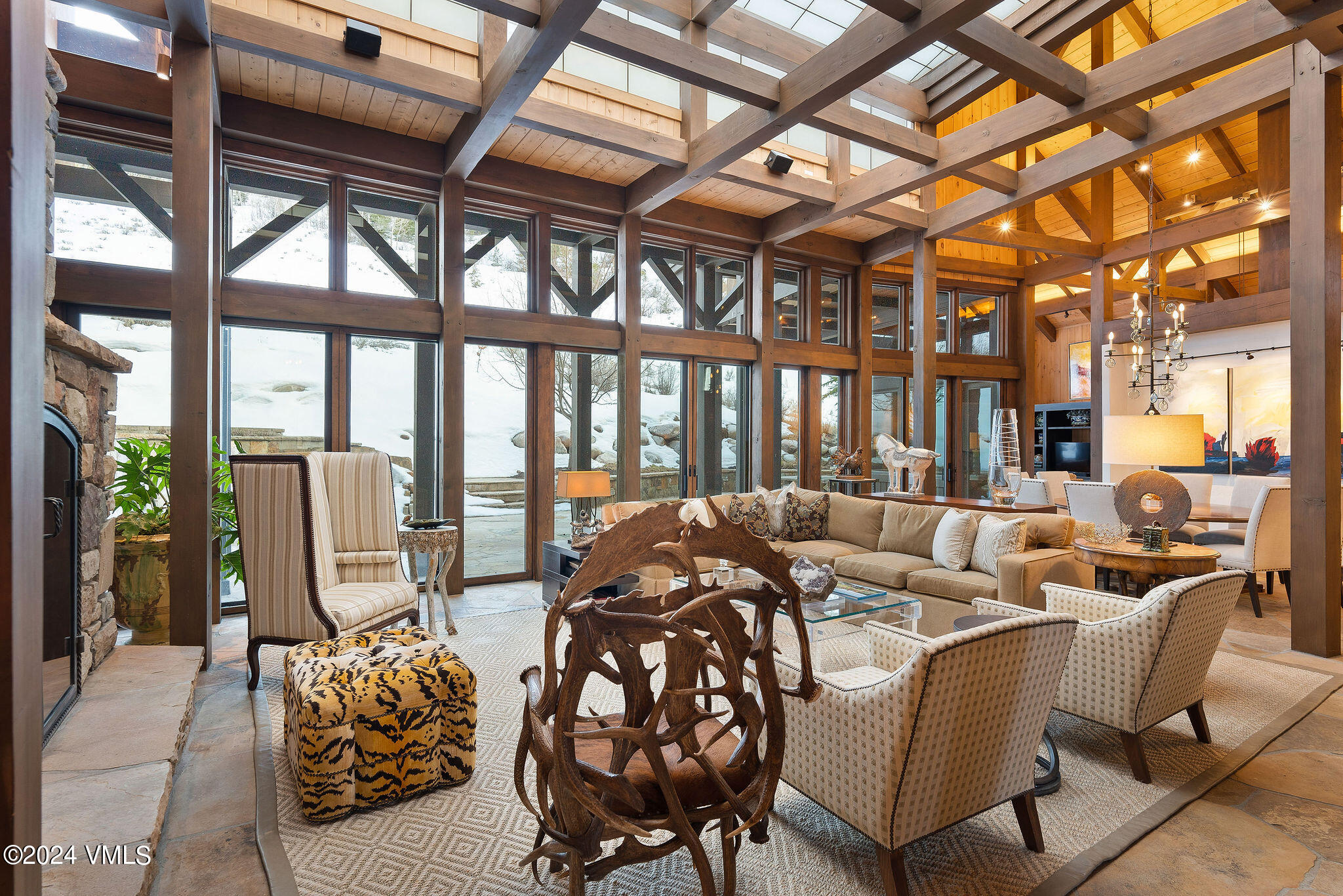 a living room with furniture and large windows