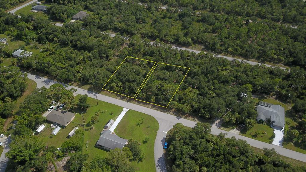 an aerial view of a house with a yard