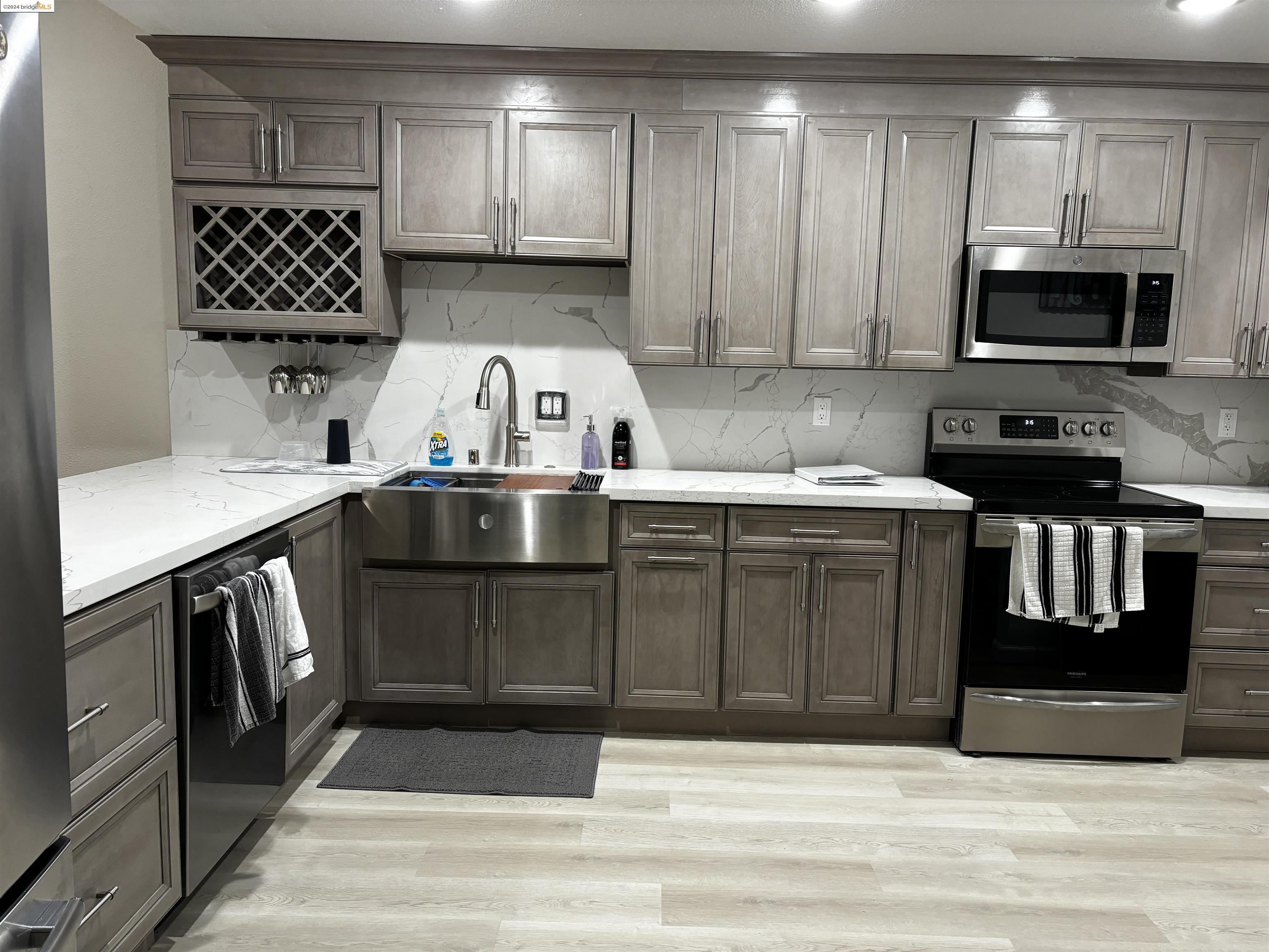 a kitchen with stainless steel appliances a stove sink microwave and cabinets