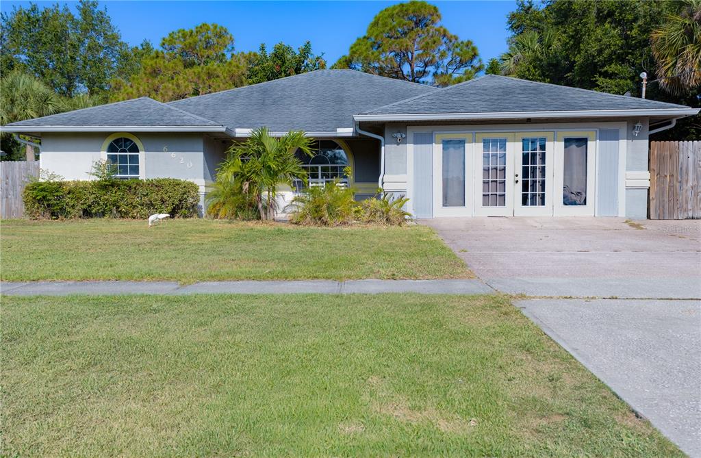 a front view of a house with a garden