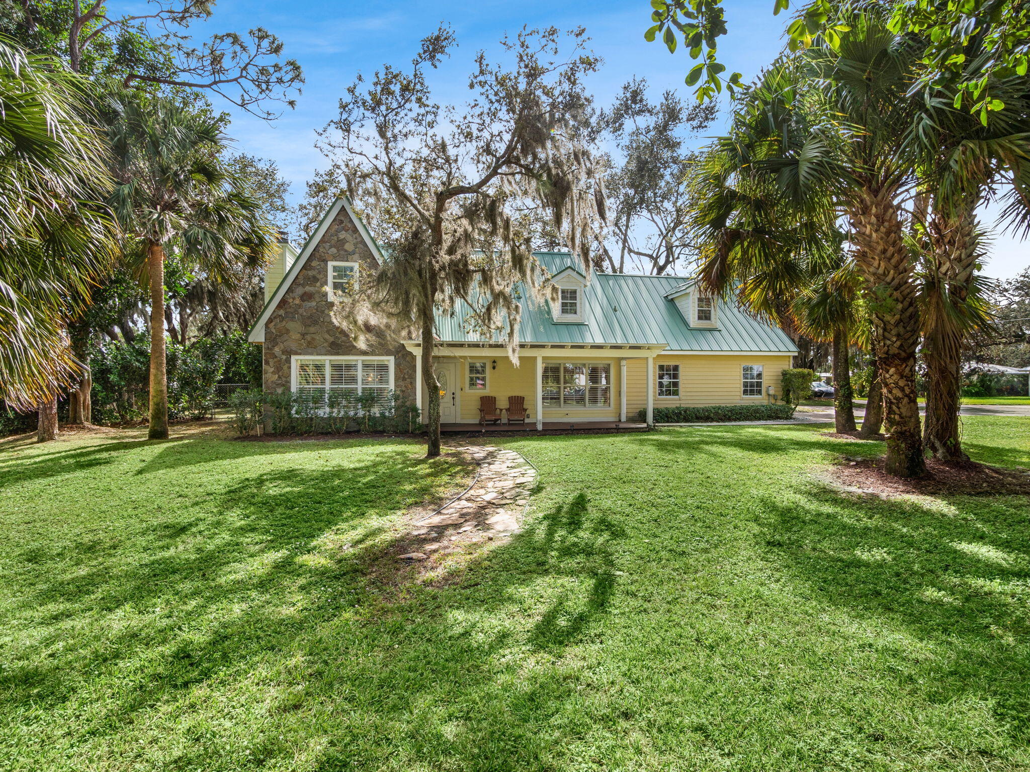 a front view of a house with a garden