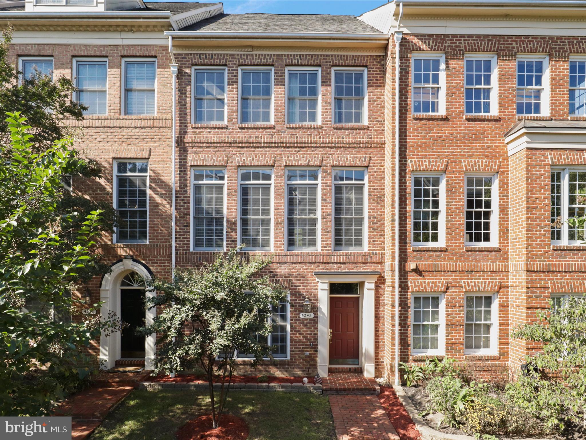 front view of a brick house with a large windows