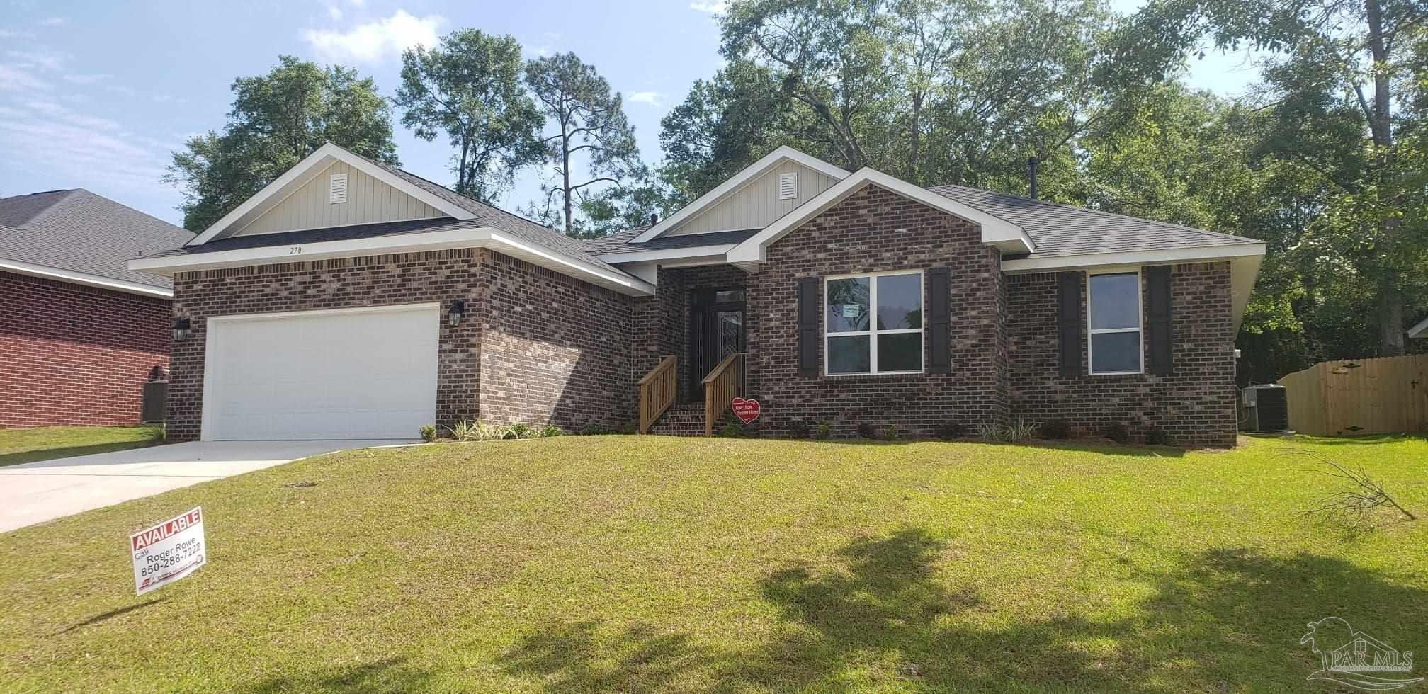 a front view of a house with yard and garage