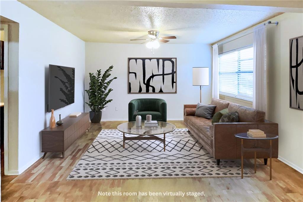 a living room with furniture a rug and a fireplace