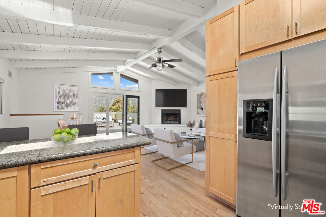 a kitchen with stainless steel appliances granite countertop a refrigerator and a sink