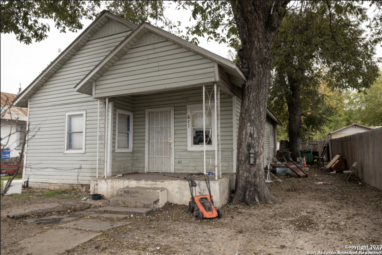 a view of a house with a yard and a patio