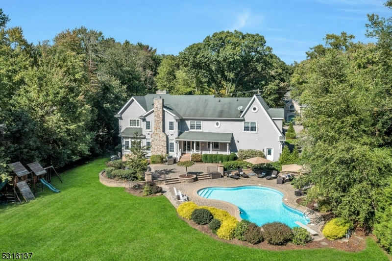 a front view of a house with swimming pool patio and outdoor seating