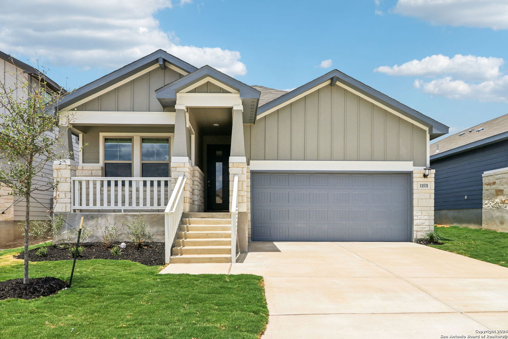 a front view of a house with a yard and garage