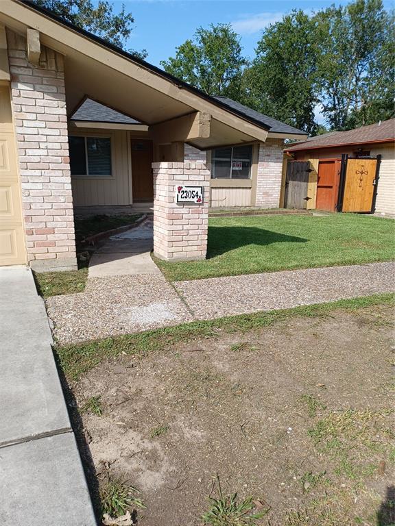 a view of a house with a yard and garage