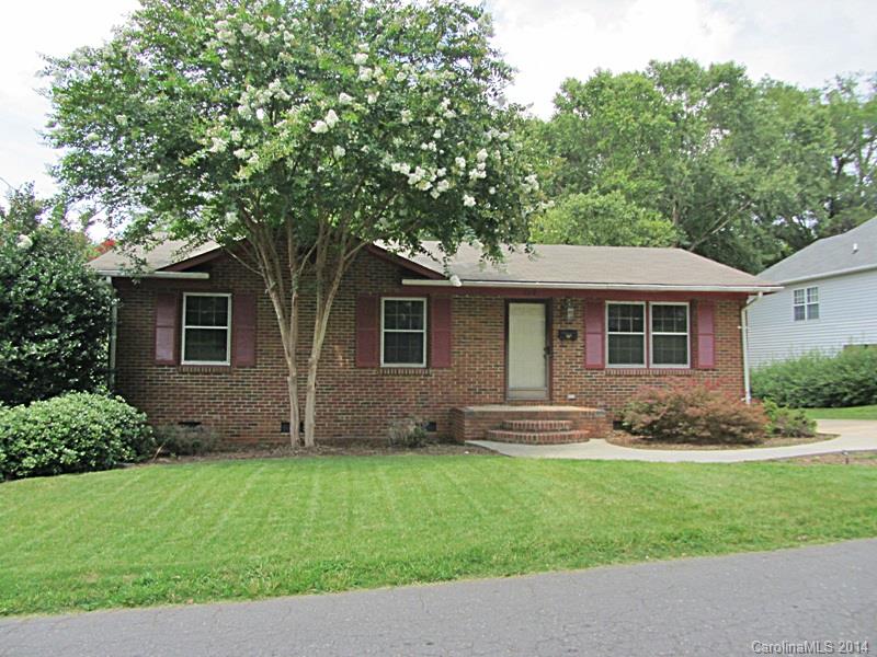 a front view of a house with a garden and yard