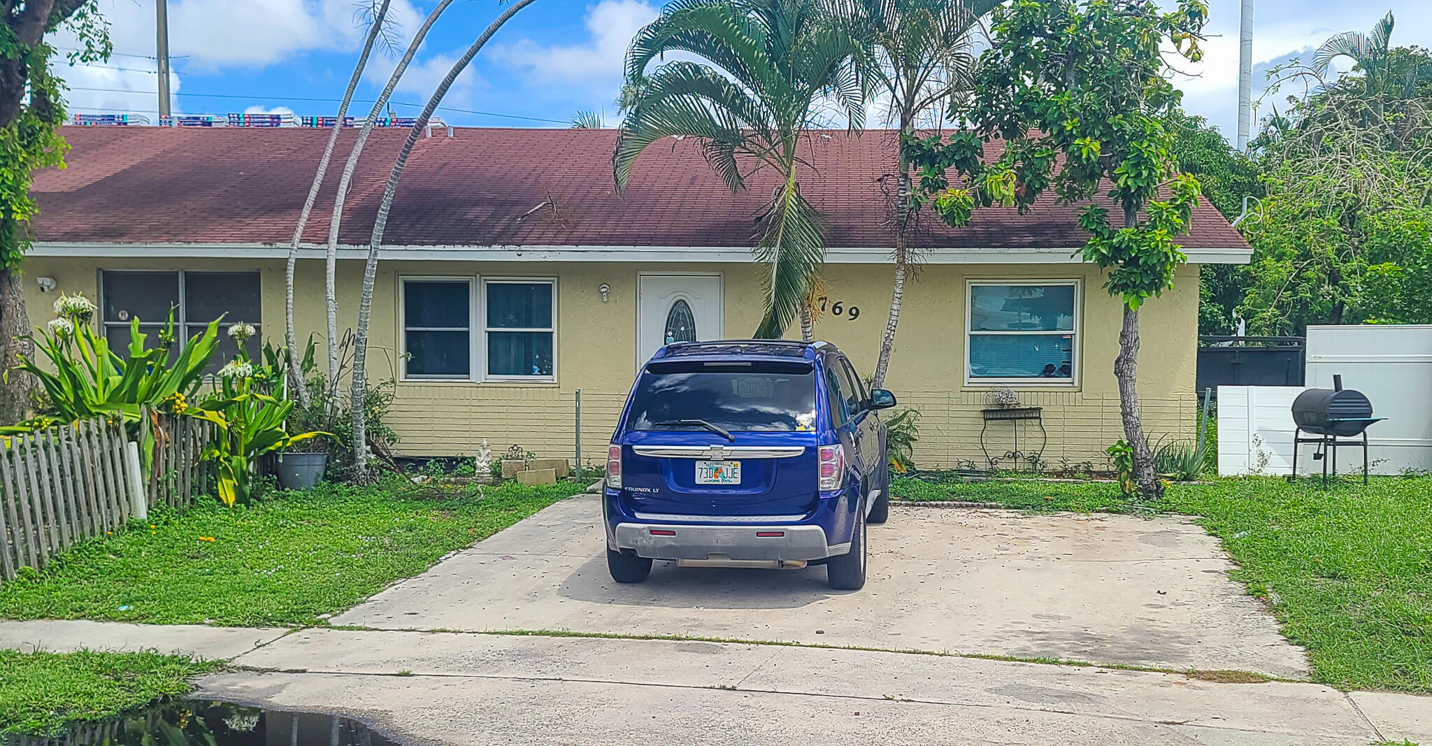 a front view of a house with a garden