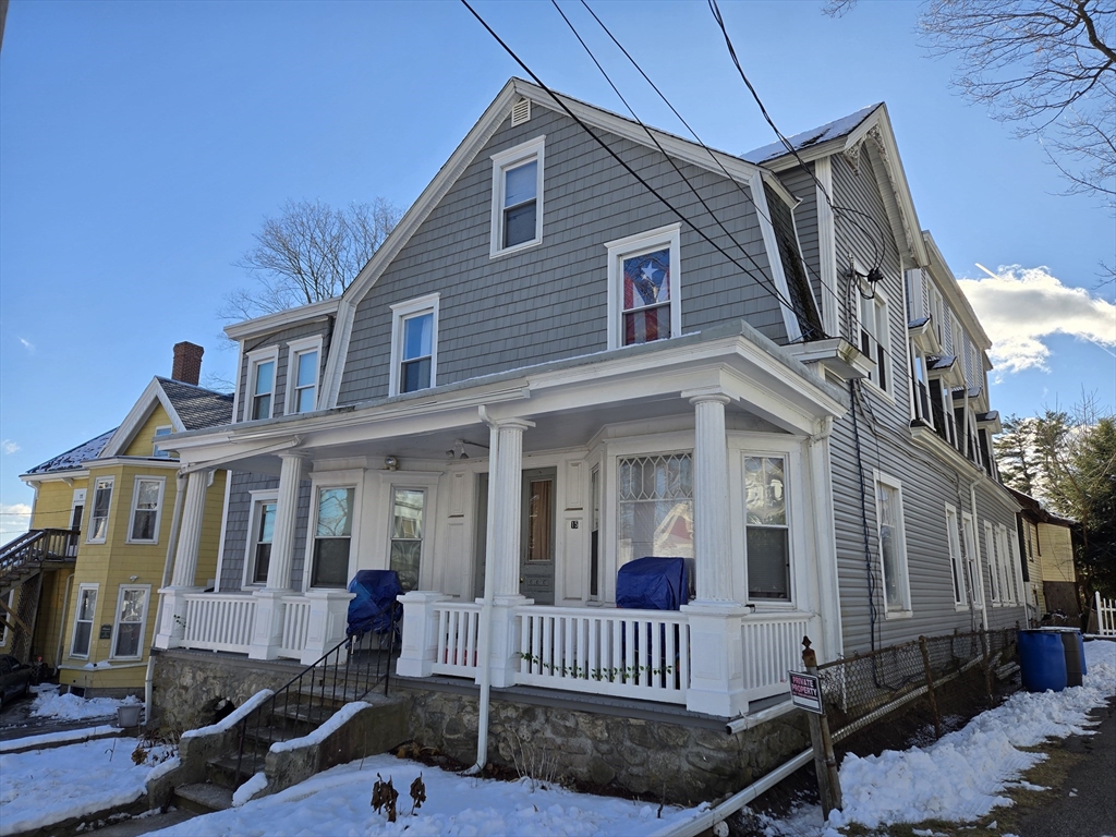 a front view of a house with iron fence