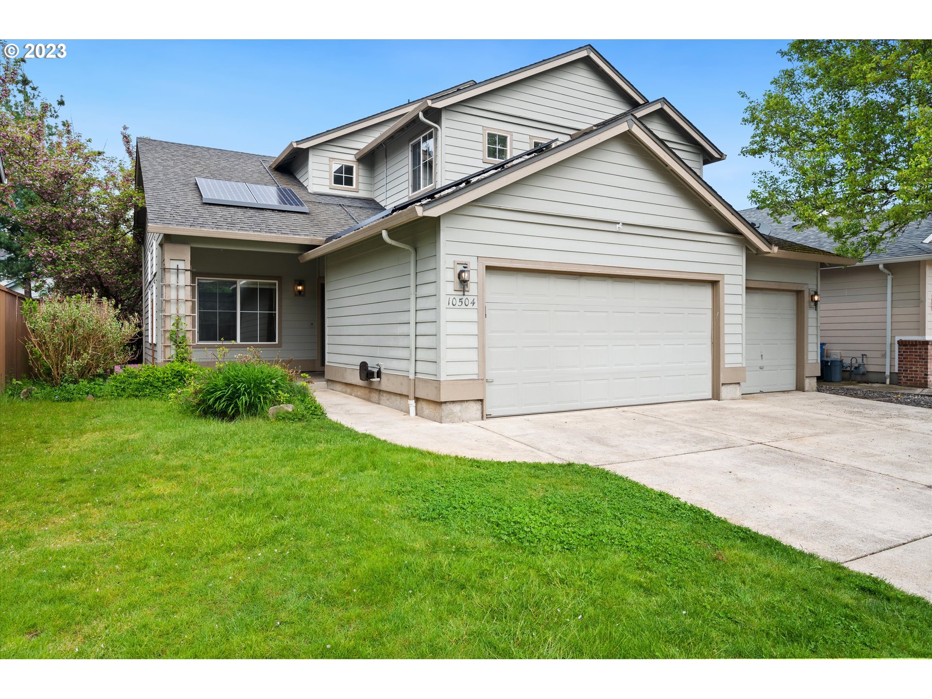 a front view of a house with a yard and garage