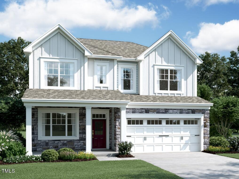 a front view of a house with a yard and garage