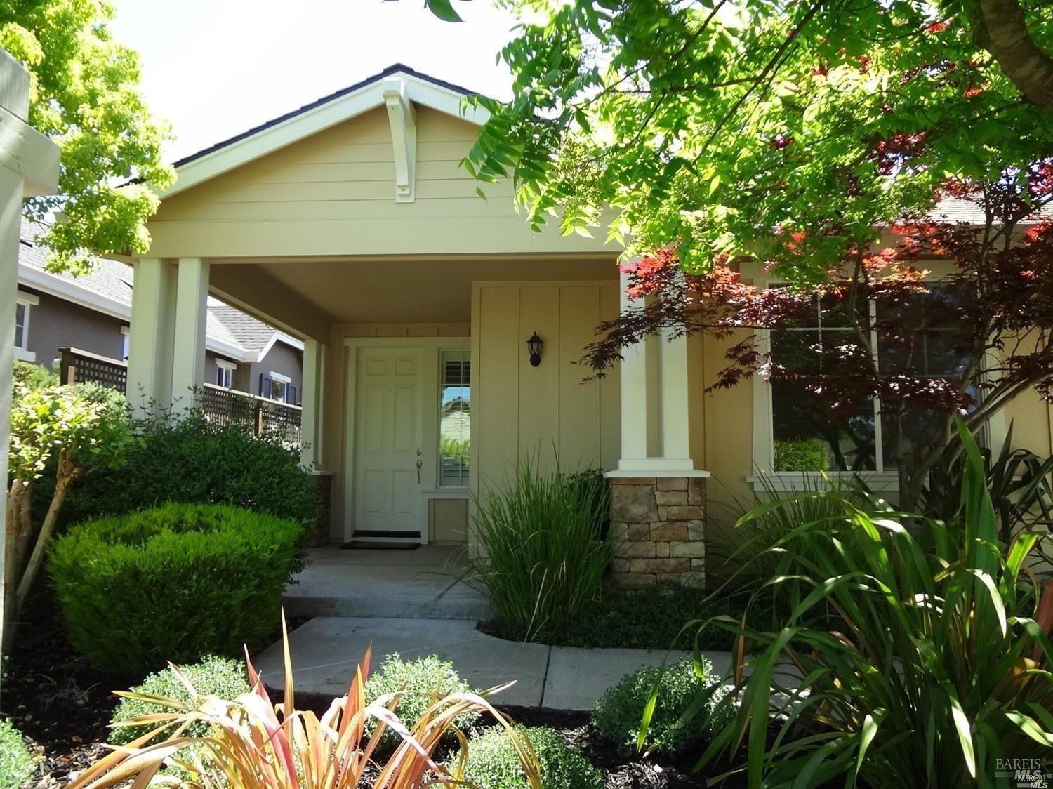 a front view of a house with garden