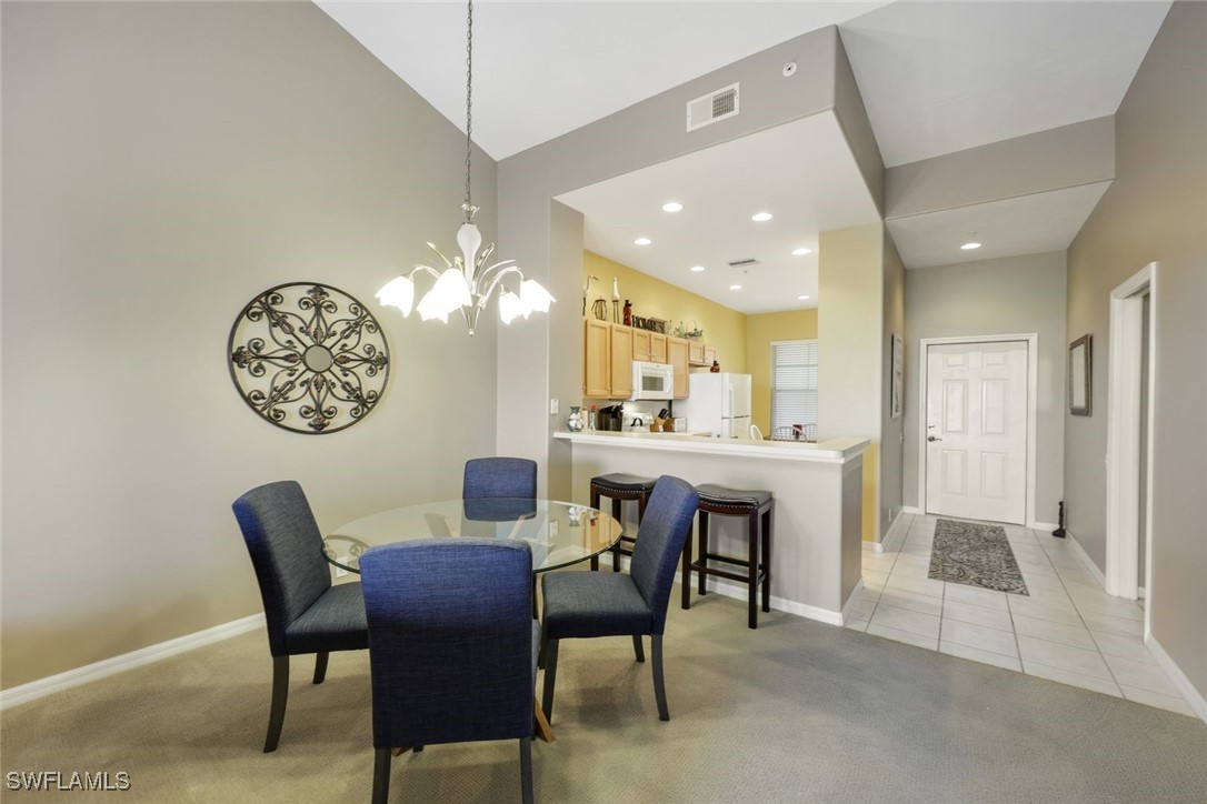 a view of a dining room with furniture and a chandelier