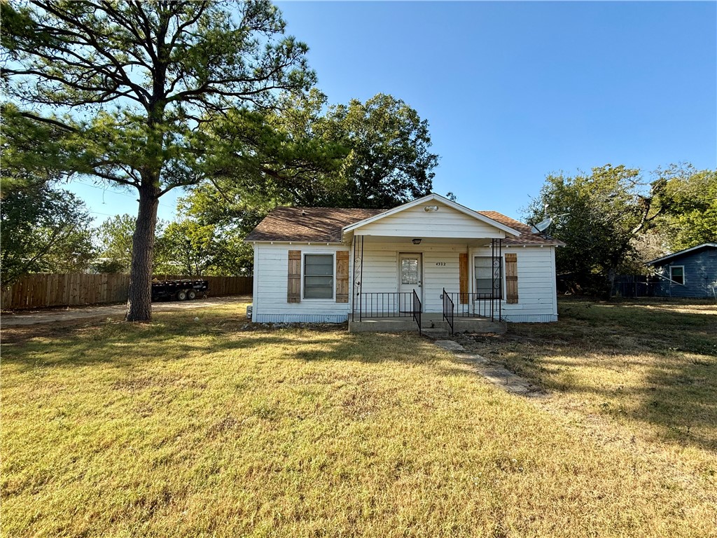 a view of a yard with a house in the background