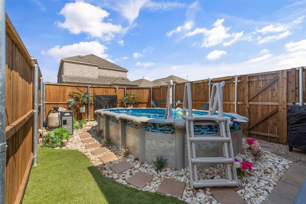 a view of swimming pool with outdoor seating and a potted plant