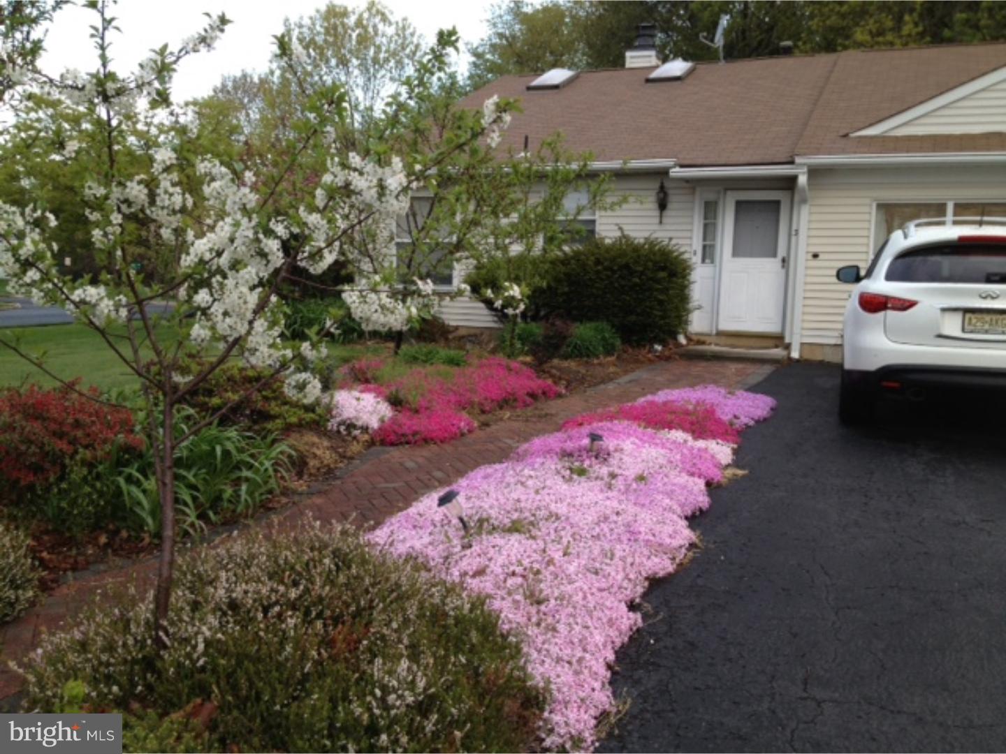 a view of a white house with a yard