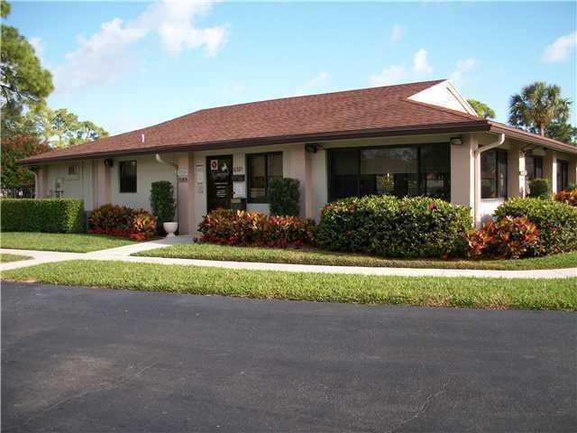 a front view of a house with a yard and porch