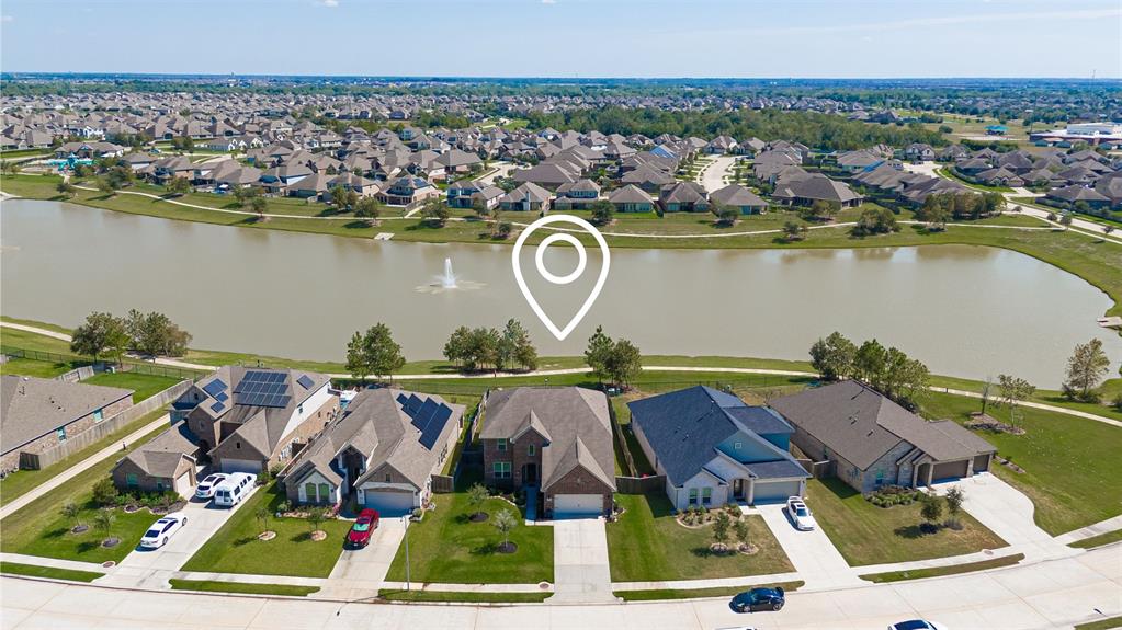 an aerial view of houses with outdoor space and lake view