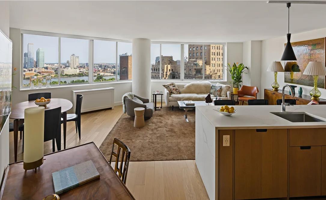 a living room with large window and furniture