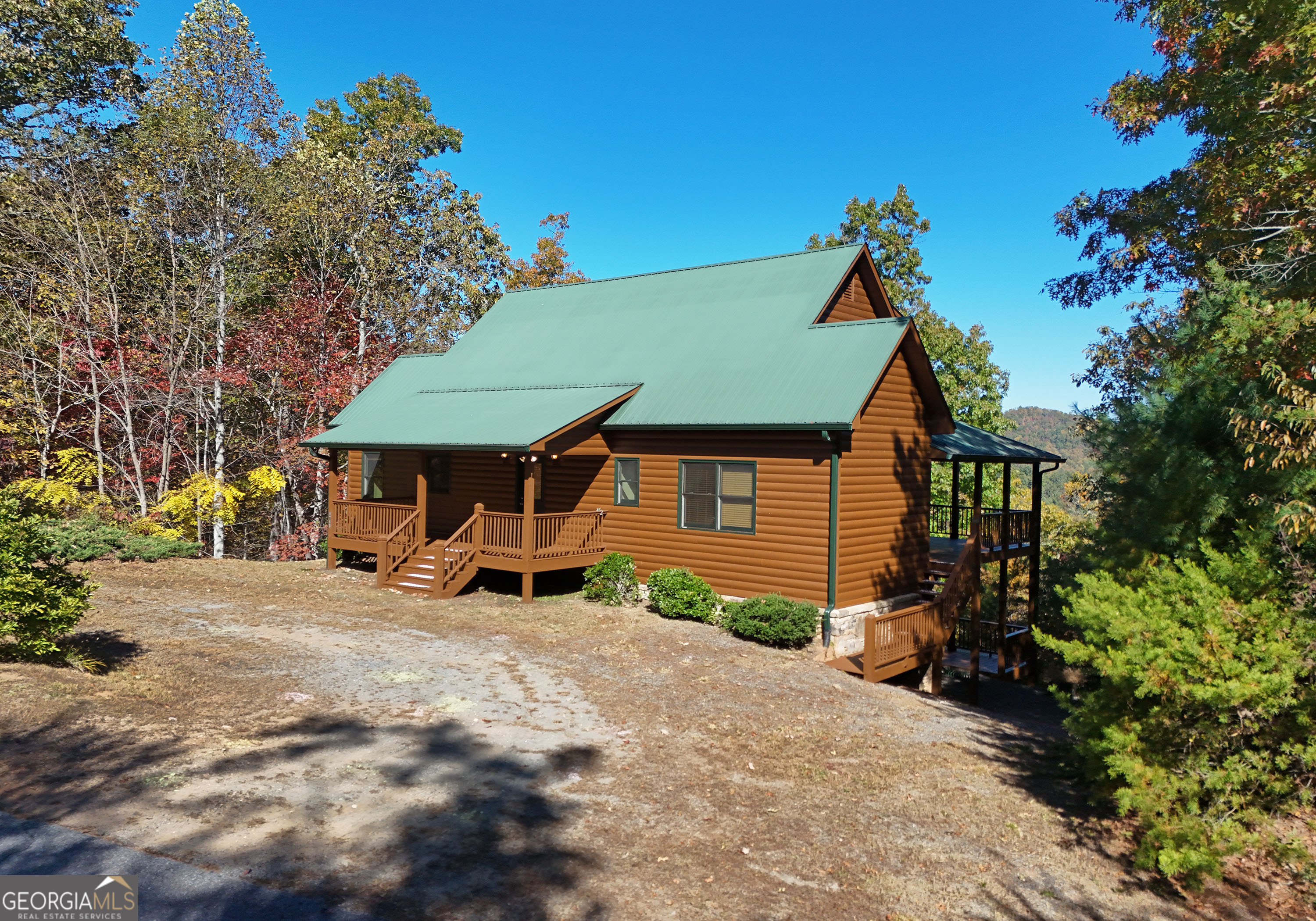 a view of a house with a yard and sitting area