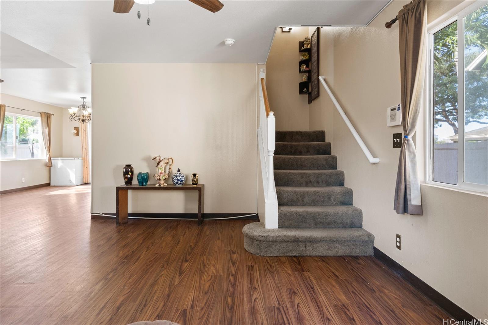 a view of entryway and hall with wooden floor