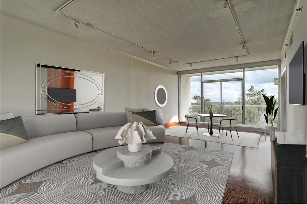 a living room with furniture and a floor to ceiling window