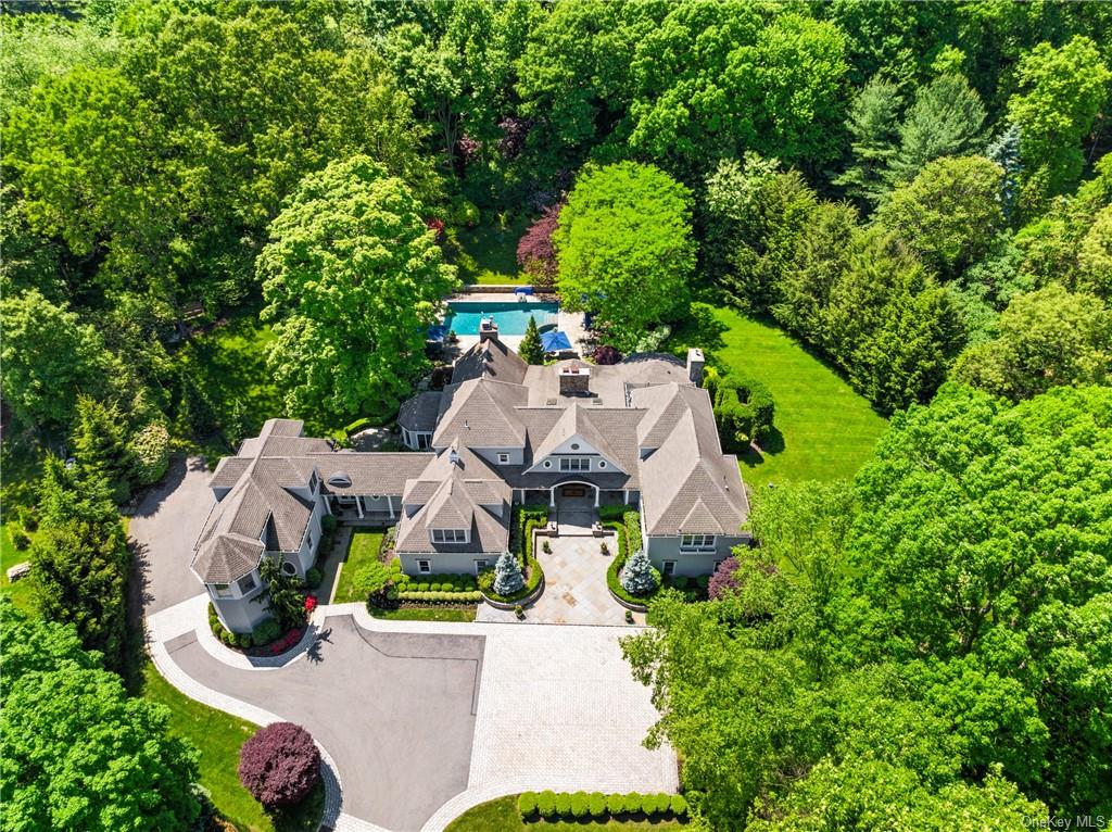 an aerial view of a house with yard swimming pool and outdoor seating