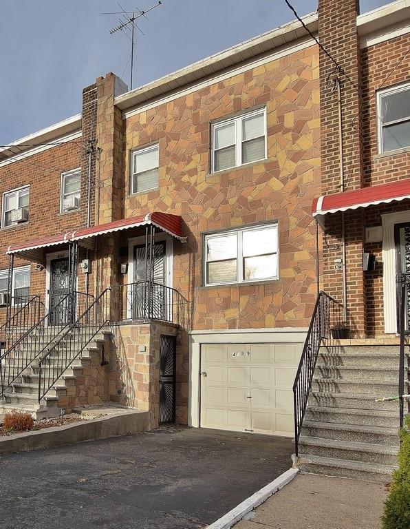 Townhome / multi-family property featuring a garage and cooling unit