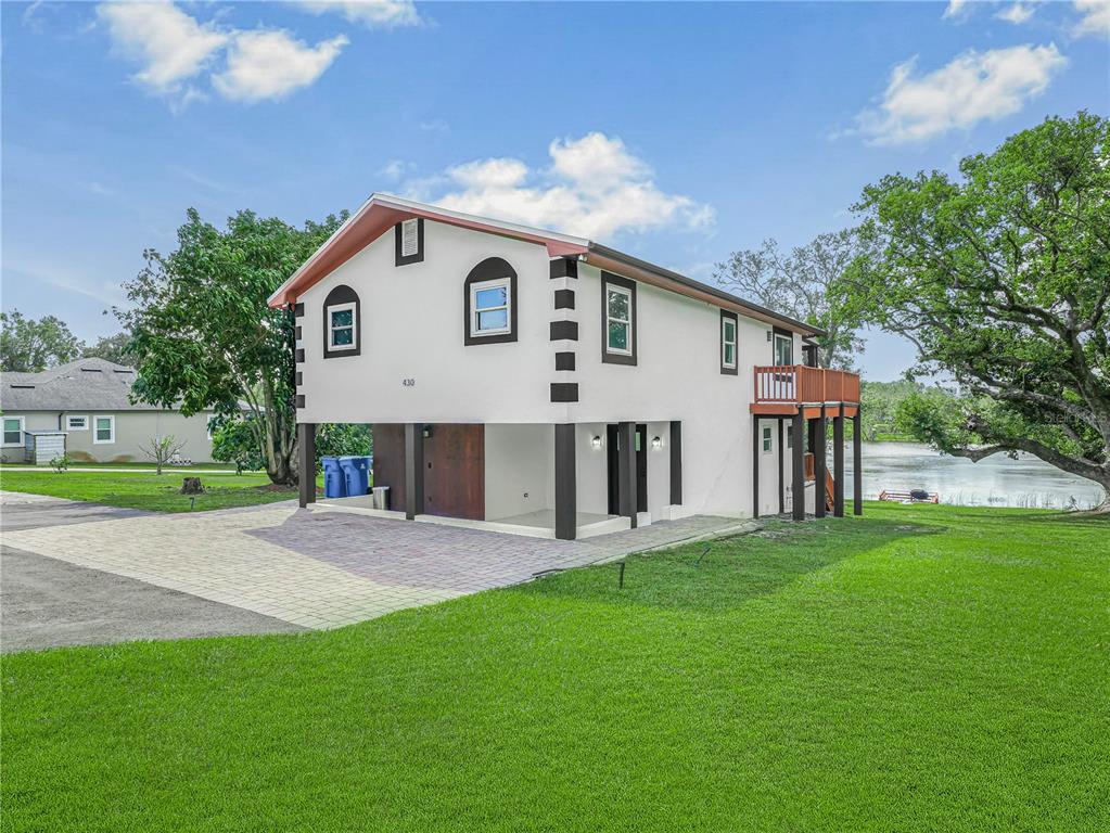 a front view of a house with a garden and yard