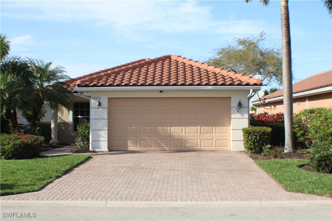 a front view of a house with a yard and garage