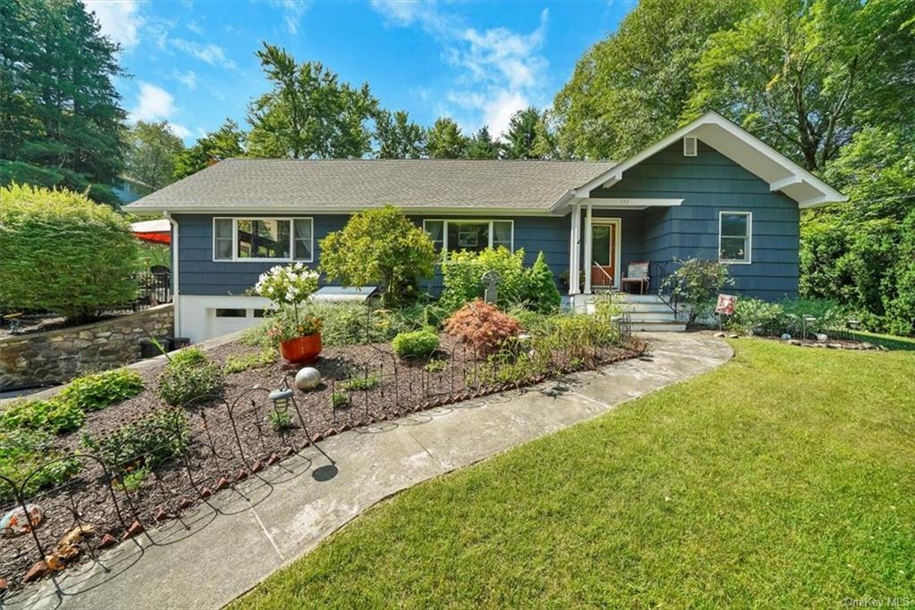 a front view of house with yard and green space