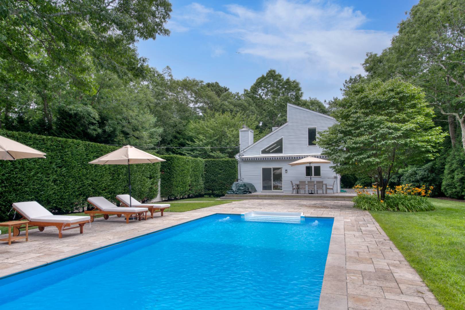 a swimming pool with outdoor seating and yard