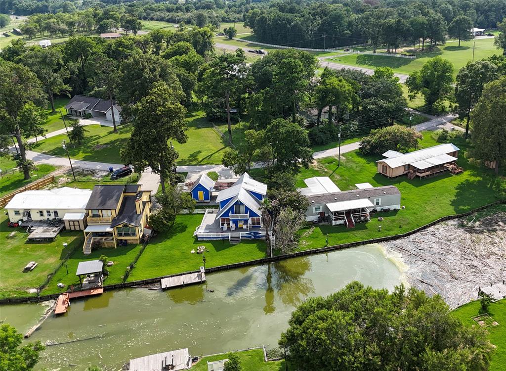 an aerial view of a house with a garden and lake view