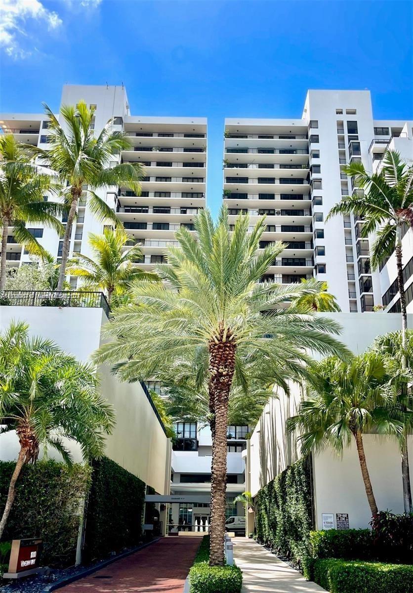 a front view of a multi story building with yard